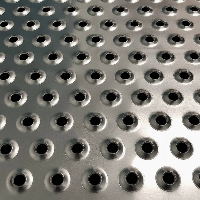 a metal sheet arranged with holes raised upwards
